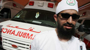 A Saudi Red Crescent aid worker stands n